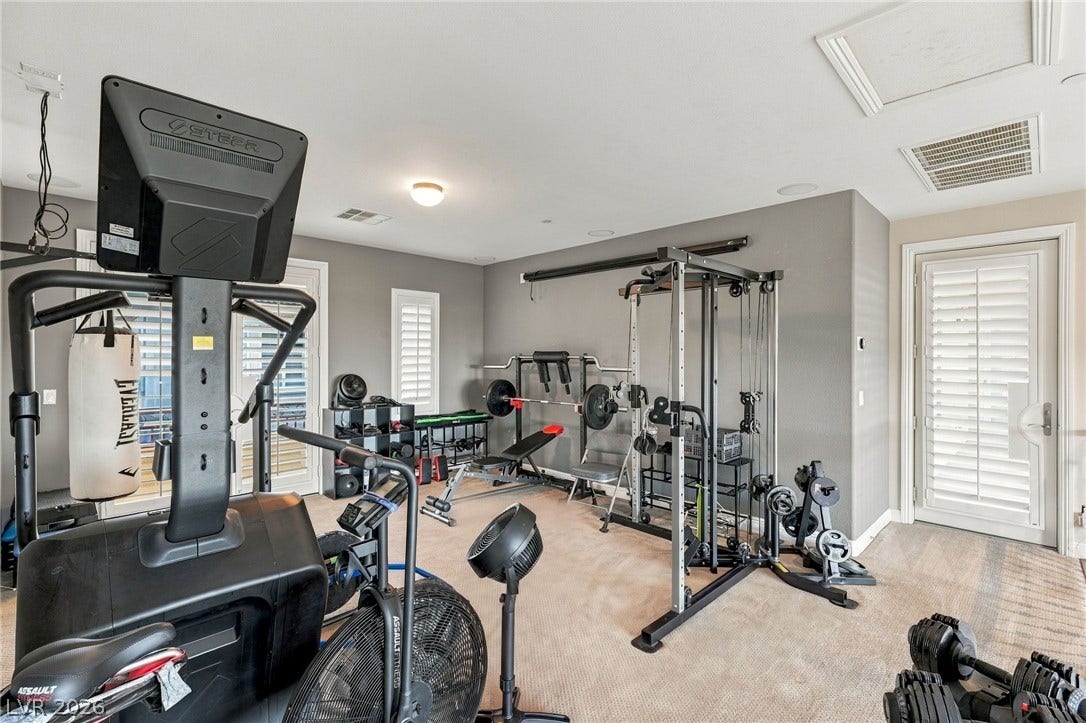 1372 Enchanted River Drive, Henderson, NV 89012 Carpeted flooring and custom plantation shutters establish a comfortable layout for this versatile home gym.