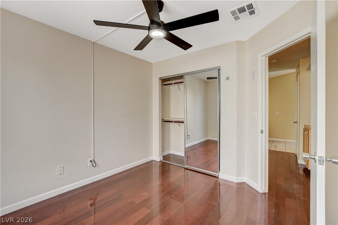 5239 Ferrell Mountain Court, North Las Vegas, NV 89031 Polished hardwood flooring guides the eye through this versatile secondary bedroom space.