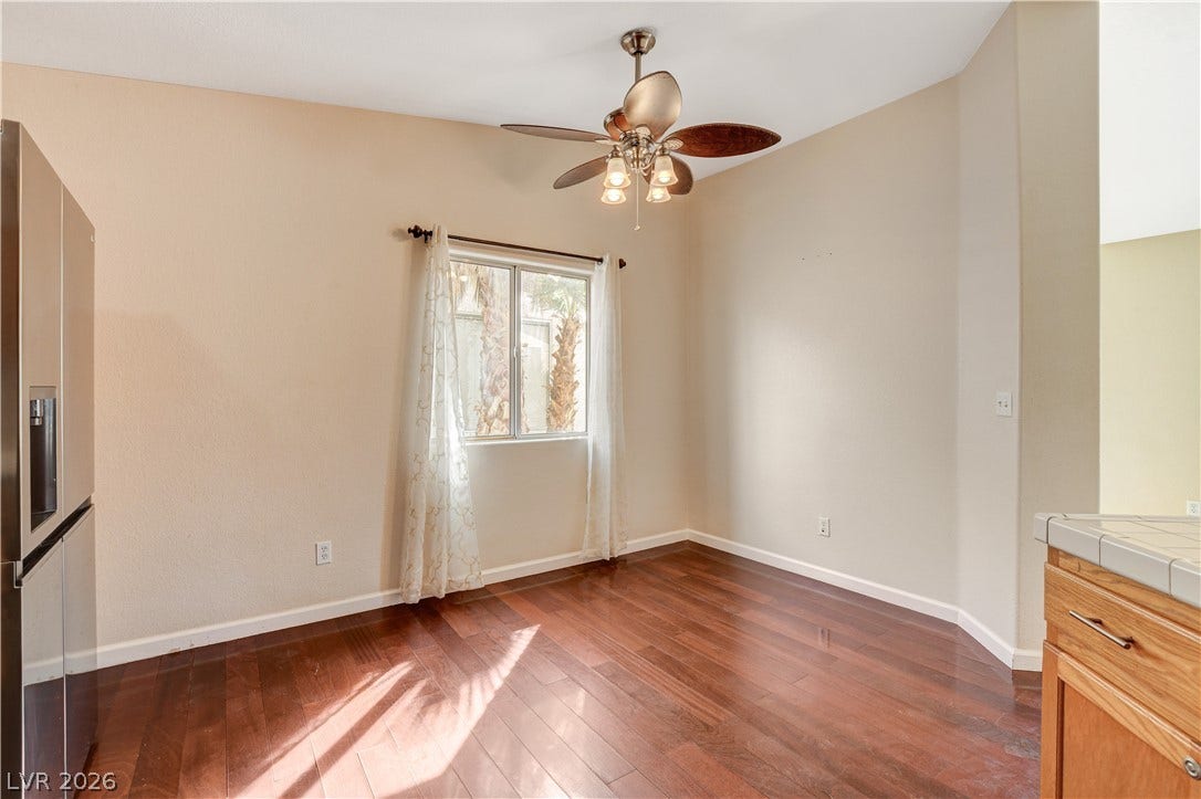 5239 Ferrell Mountain Court, North Las Vegas, NV 89031 Rich hardwood flooring anchors this versatile dining area illuminated by a classic window.
