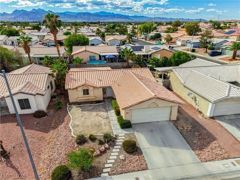 5239 Ferrell Mountain Court, North Las Vegas, NV 89031 A classic tile roof and low-maintenance desert landscaping define this inviting suburban home.