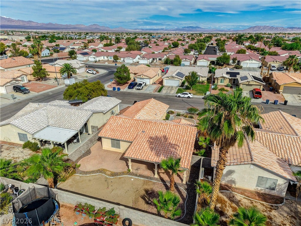 5239 Ferrell Mountain Court, North Las Vegas, NV 89031 An aerial view showcases tile roofing and a private yard set against a mountain backdrop.