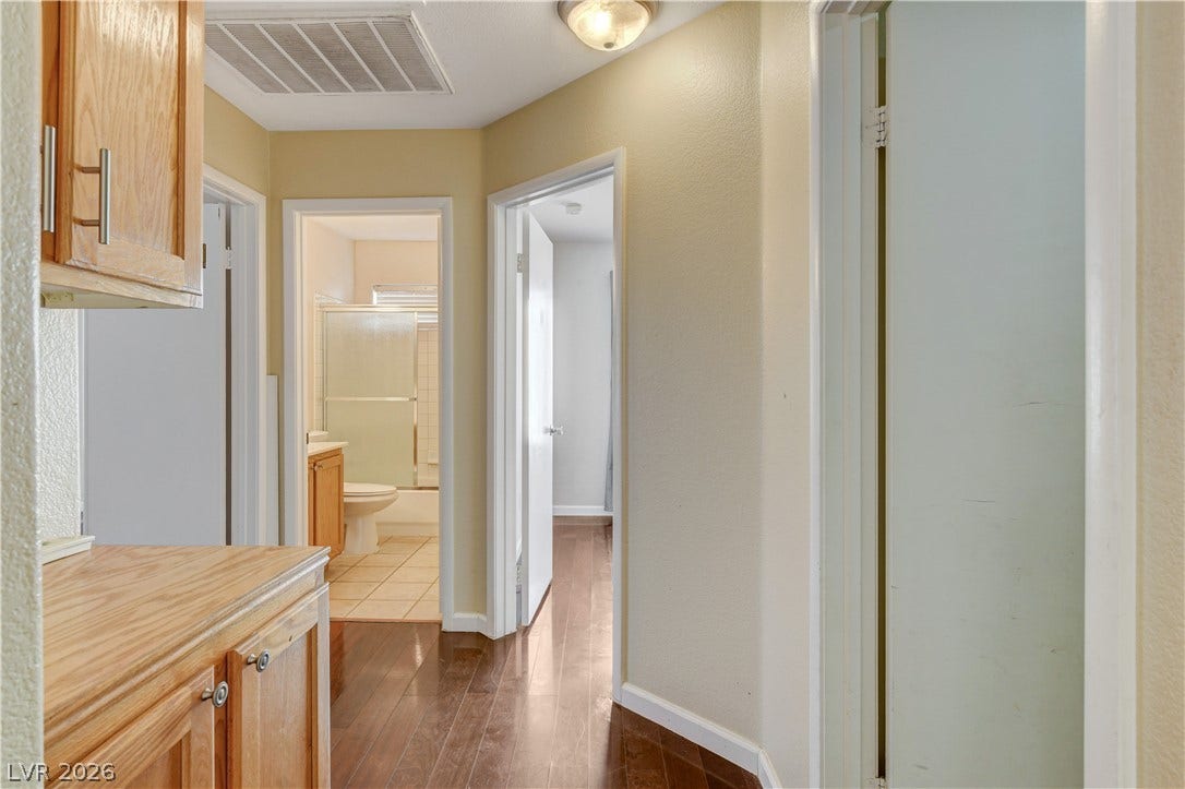 5239 Ferrell Mountain Court, North Las Vegas, NV 89031 Gleaming hardwood floors run throughout this central hallway connecting multiple living spaces.