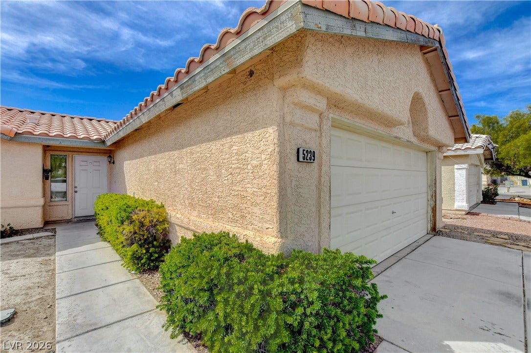 5239 Ferrell Mountain Court, North Las Vegas, NV 89031 Stucco exterior and Spanish tile roof define this classic desert-style residence.