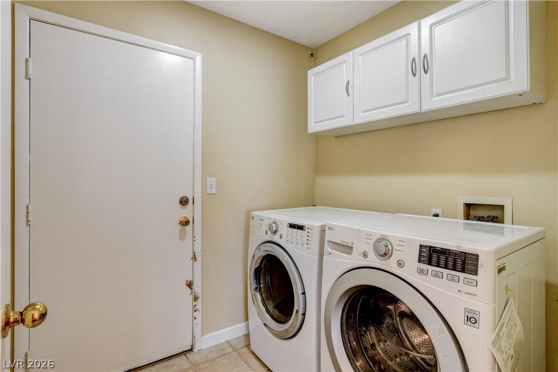5239 Ferrell Mountain Court, North Las Vegas, NV 89031 A functional laundry area is equipped with built-in cabinetry and durable tile flooring.