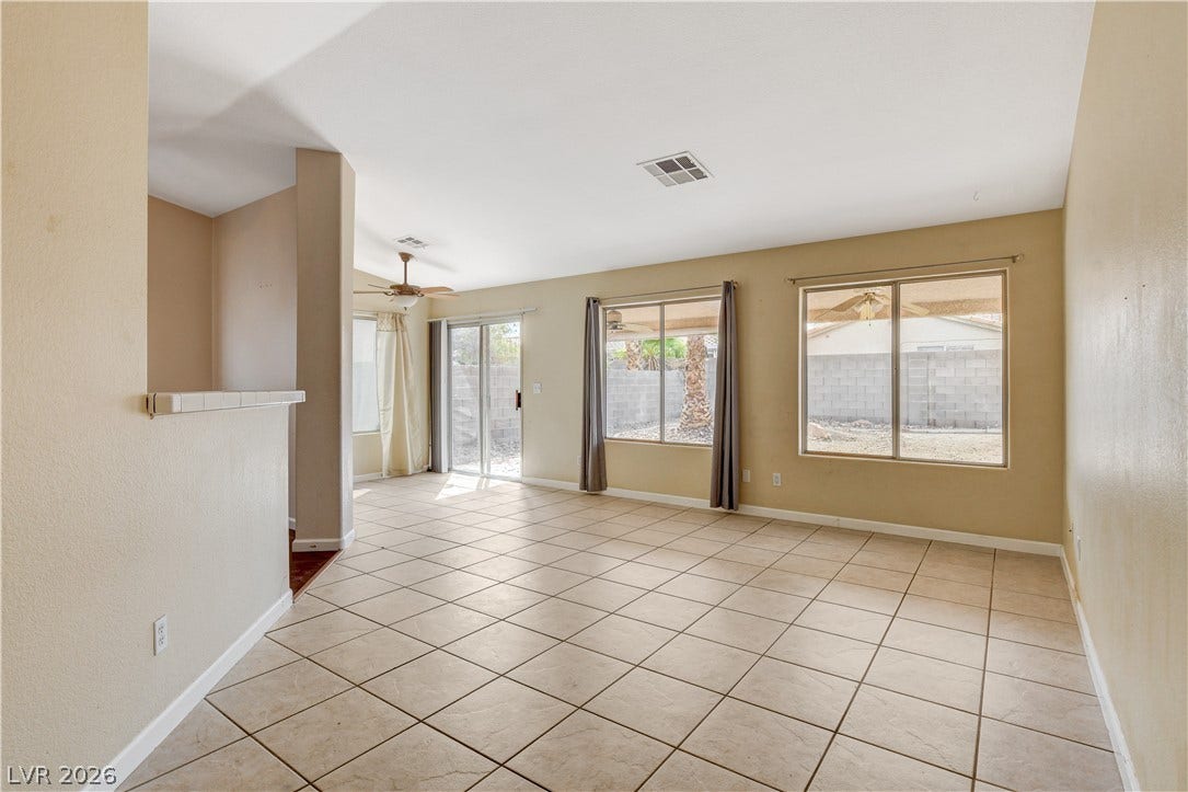 5239 Ferrell Mountain Court, North Las Vegas, NV 89031 Tiled flooring and large windows create a spacious feel in this open living area.
