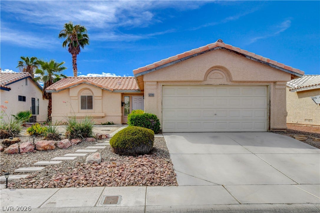 5239 Ferrell Mountain Court, North Las Vegas, NV 89031 Classic stucco exterior and barrel tile roof line this desert-landscaped single-level home.