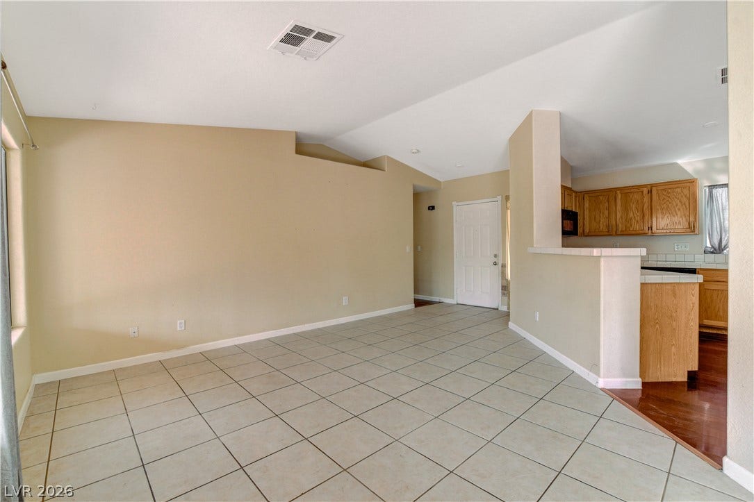 5239 Ferrell Mountain Court, North Las Vegas, NV 89031 Tiled flooring and high vaulted ceilings define this versatile open living space.