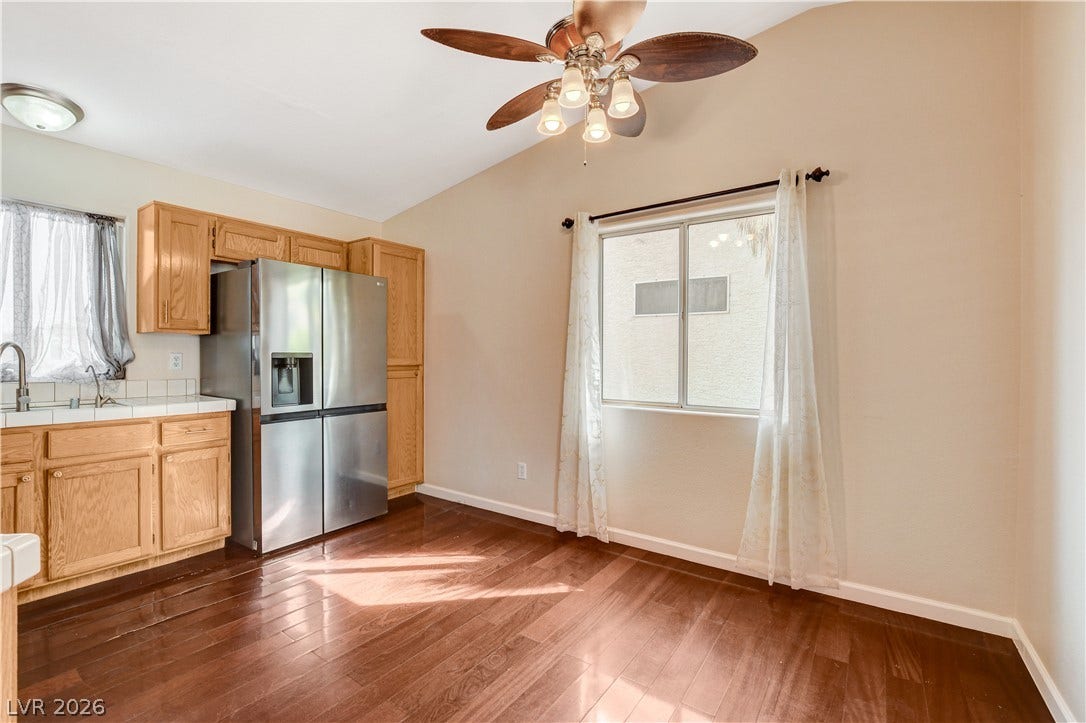 5239 Ferrell Mountain Court, North Las Vegas, NV 89031 Rich hardwood flooring complements the vaulted ceiling in this functional eat-in kitchen layout.