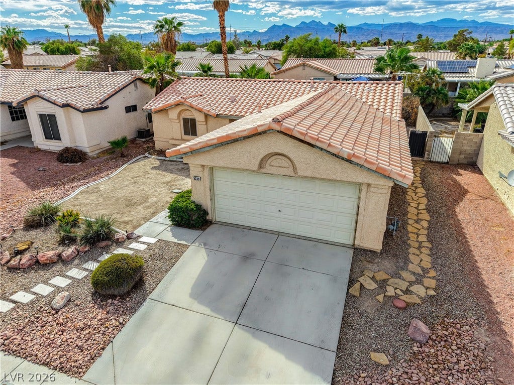 5239 Ferrell Mountain Court, North Las Vegas, NV 89031 Classic tile roofing and structured stucco walls define this desert home design.