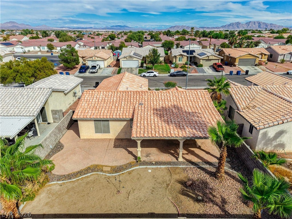 5239 Ferrell Mountain Court, North Las Vegas, NV 89031 A spacious backyard patio area with a covered overhang overlooks a low-maintenance desert landscape.