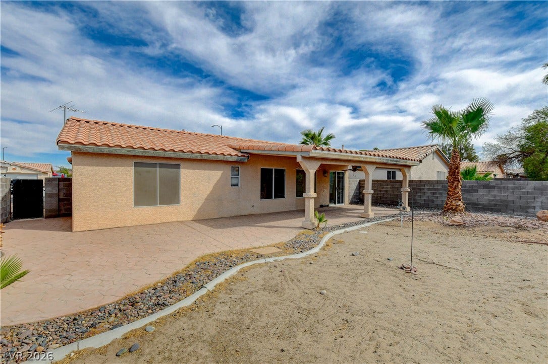 5239 Ferrell Mountain Court, North Las Vegas, NV 89031 A spacious covered patio lines the rear facade of this Spanish tile roof residence.