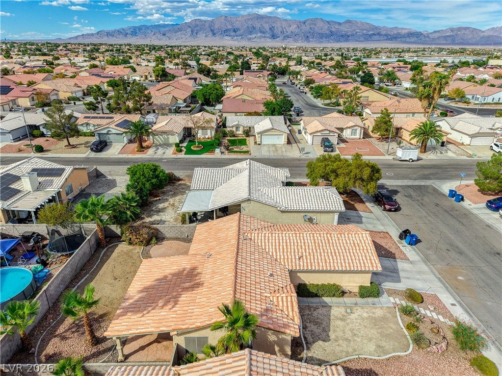 5239 Ferrell Mountain Court, North Las Vegas, NV 89031 A quiet suburban neighborhood unfolds beneath a dramatic desert mountain backdrop.