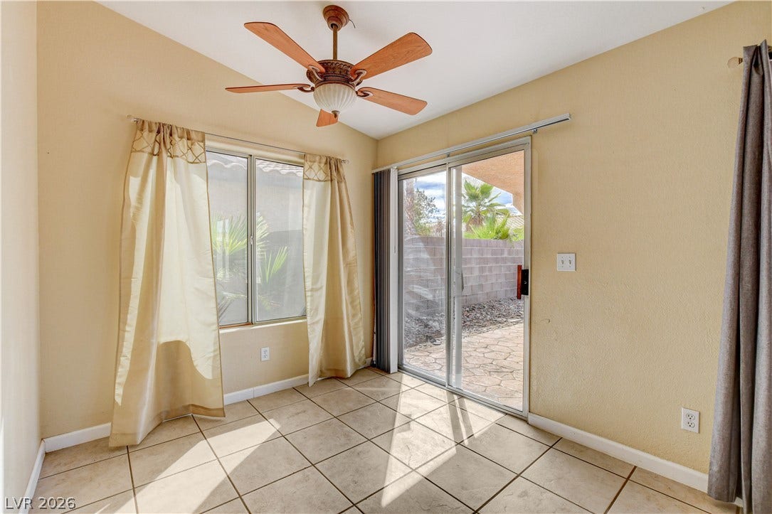 5239 Ferrell Mountain Court, North Las Vegas, NV 89031 Sliding glass doors open directly to a stone patio from this tile-floored dining area.