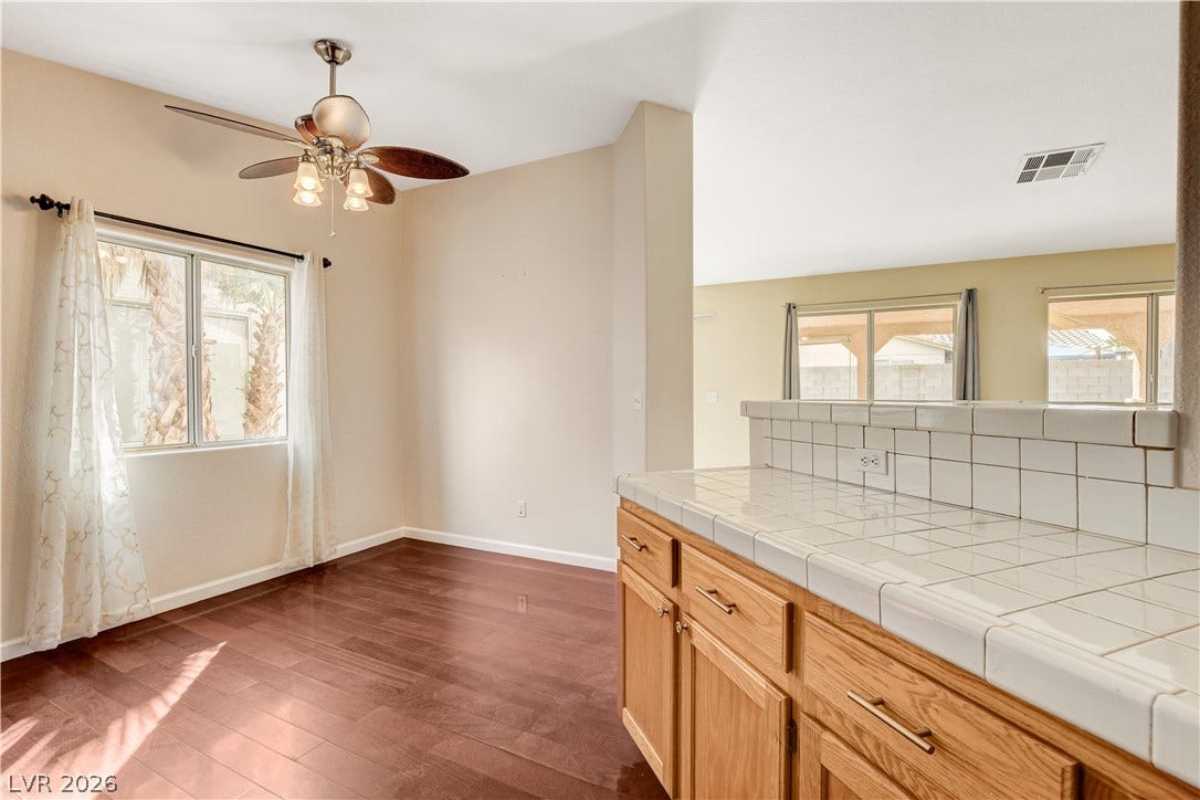 5239 Ferrell Mountain Court, North Las Vegas, NV 89031 Hardwood floors and tiled breakfast bar surfaces connect the versatile dining areas.