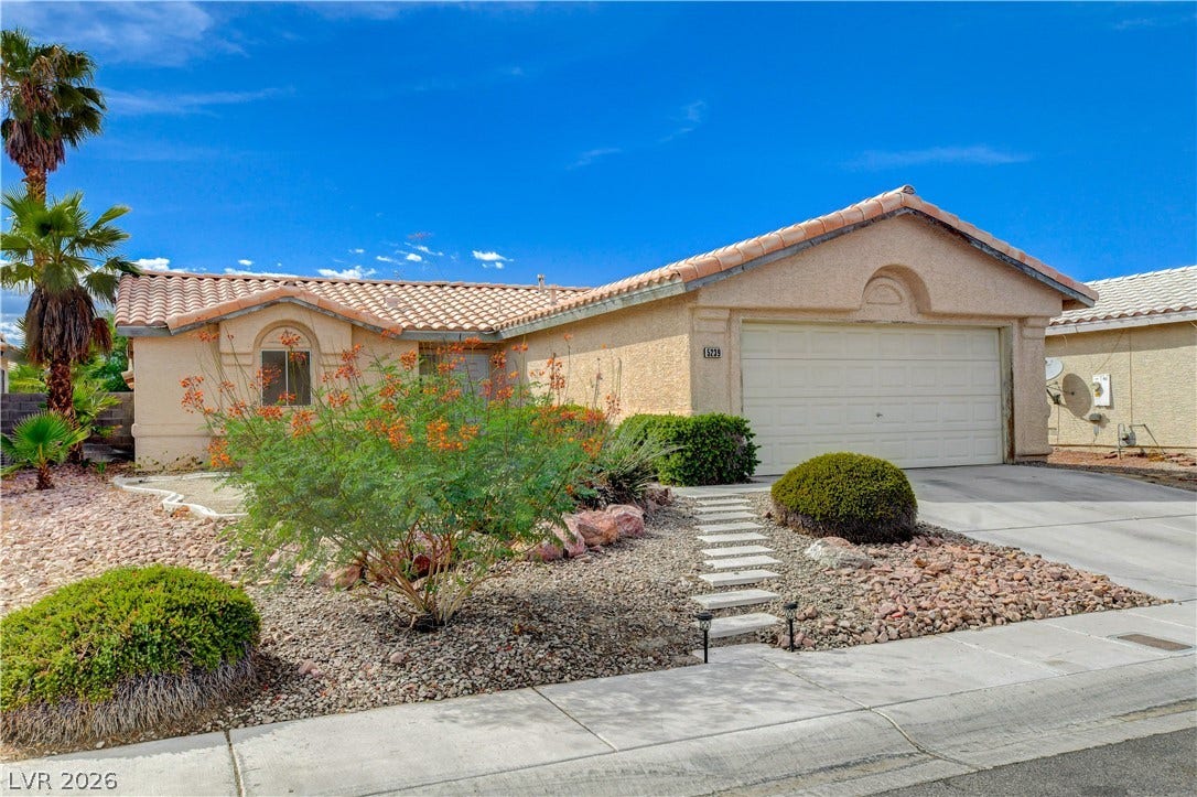 5239 Ferrell Mountain Court, North Las Vegas, NV 89031 Classic stucco exterior and tile roofing define this desert-landscaped single-level residence.