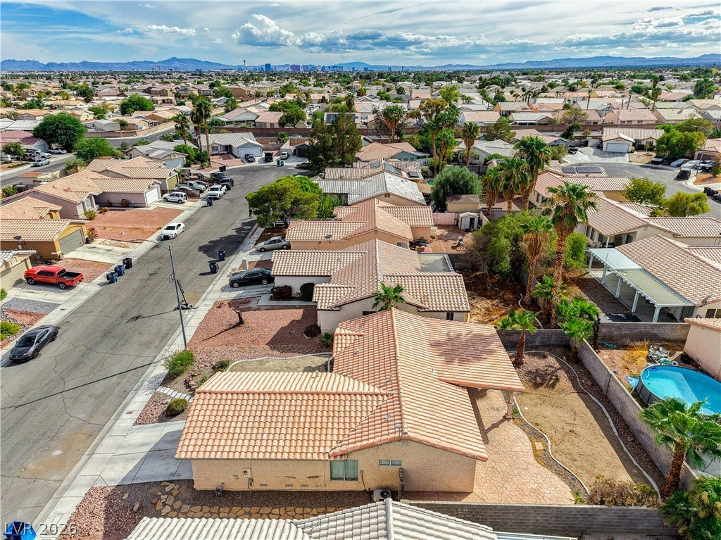 5239 Ferrell Mountain Court, North Las Vegas, NV 89031 An elevated perspective showcases classic tiled roofs and distant mountain ridges under a wide sky.
