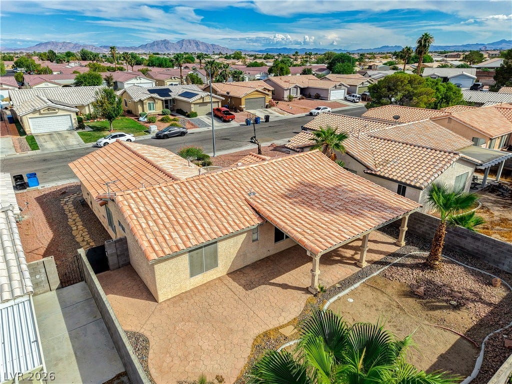 5239 Ferrell Mountain Court, North Las Vegas, NV 89031 Sun-drenched desert mountain backdrops frame this classic Spanish tile roof and expansive paved patio.