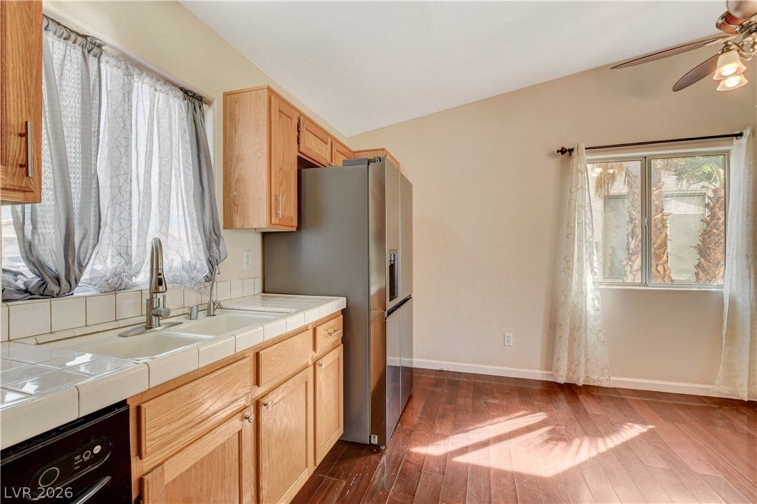 5239 Ferrell Mountain Court, North Las Vegas, NV 89031 Warm wood flooring and classic tile countertops define this functional culinary space.