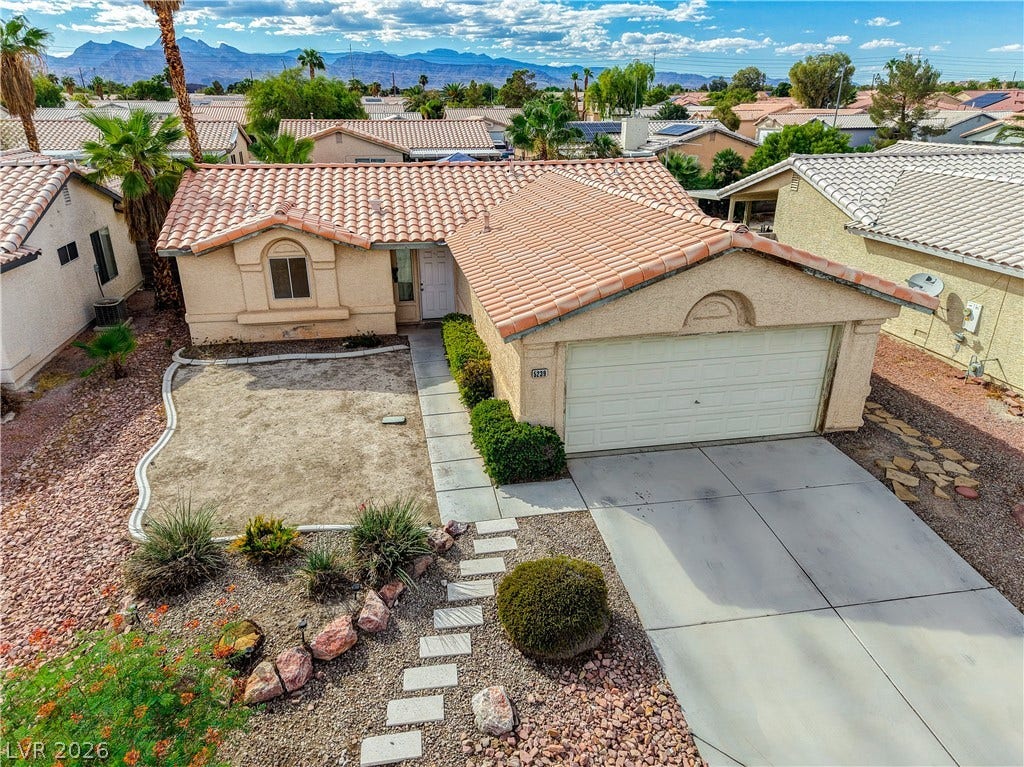 5239 Ferrell Mountain Court, North Las Vegas, NV 89031 Tiled roofs and scenic mountain backdrops define this classic desert-style residence.