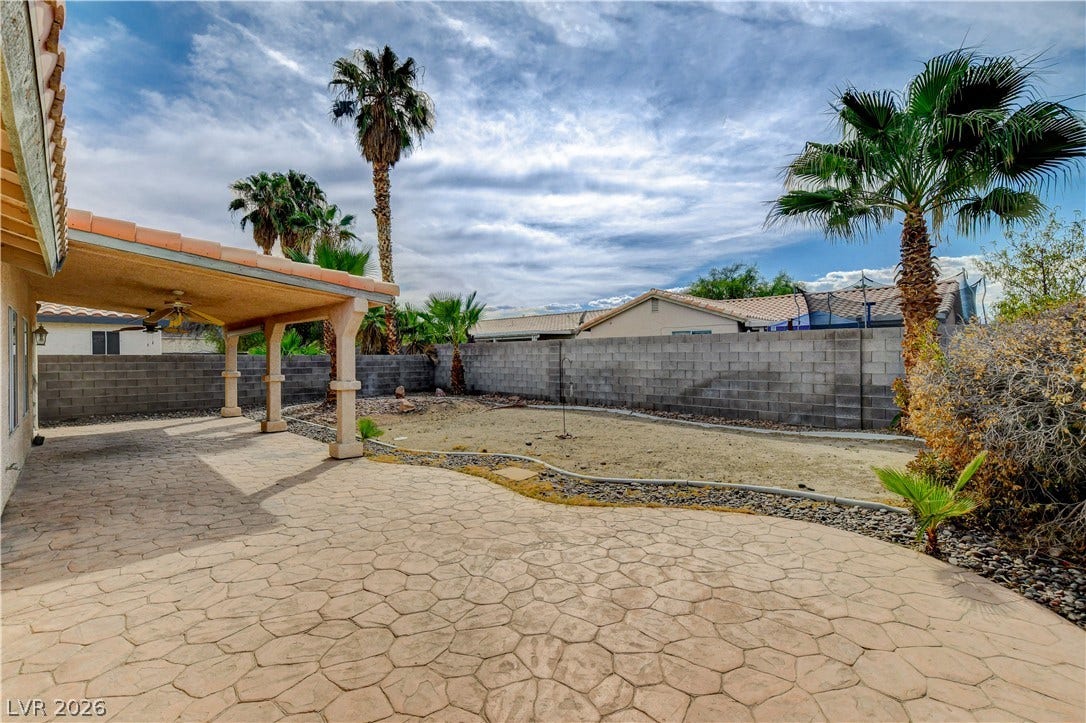 5239 Ferrell Mountain Court, North Las Vegas, NV 89031 An expansive stamped concrete patio extends outward, bordered by a private block wall fence.