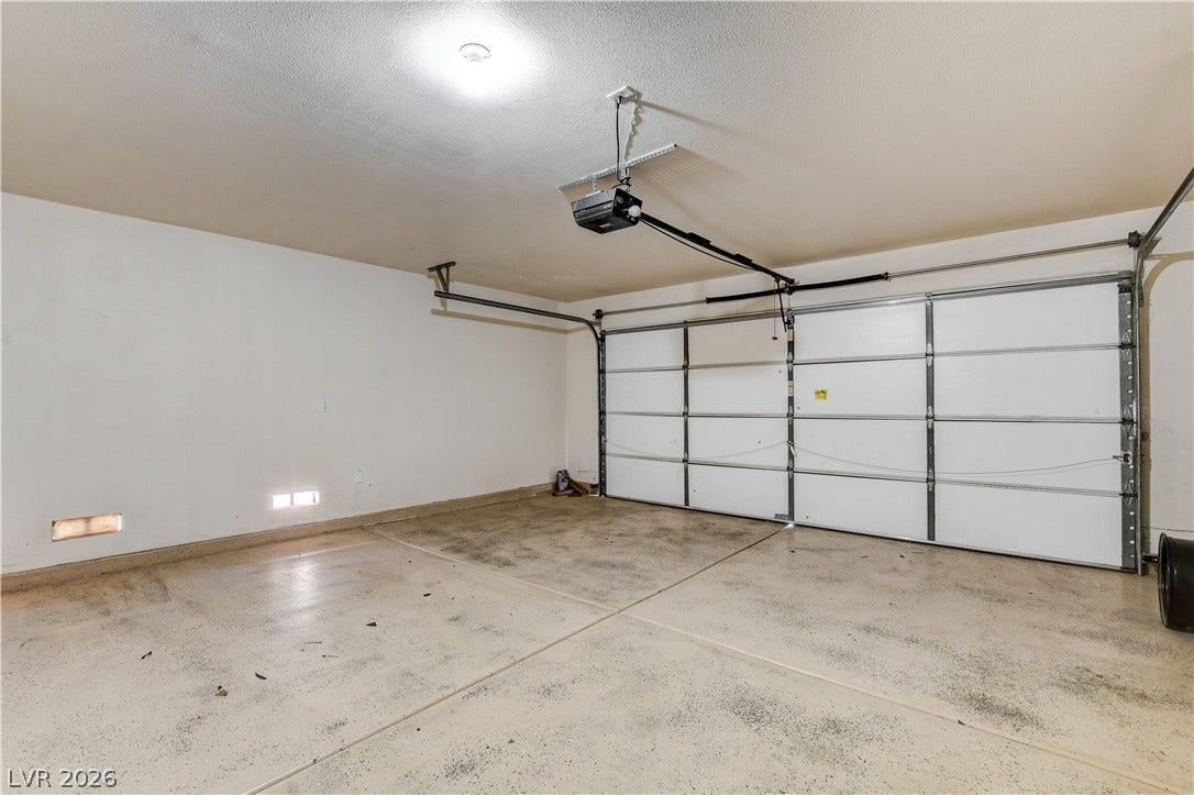 5239 Ferrell Mountain Court, North Las Vegas, NV 89031 A spacious garage features durable concrete flooring and an automated overhead door.