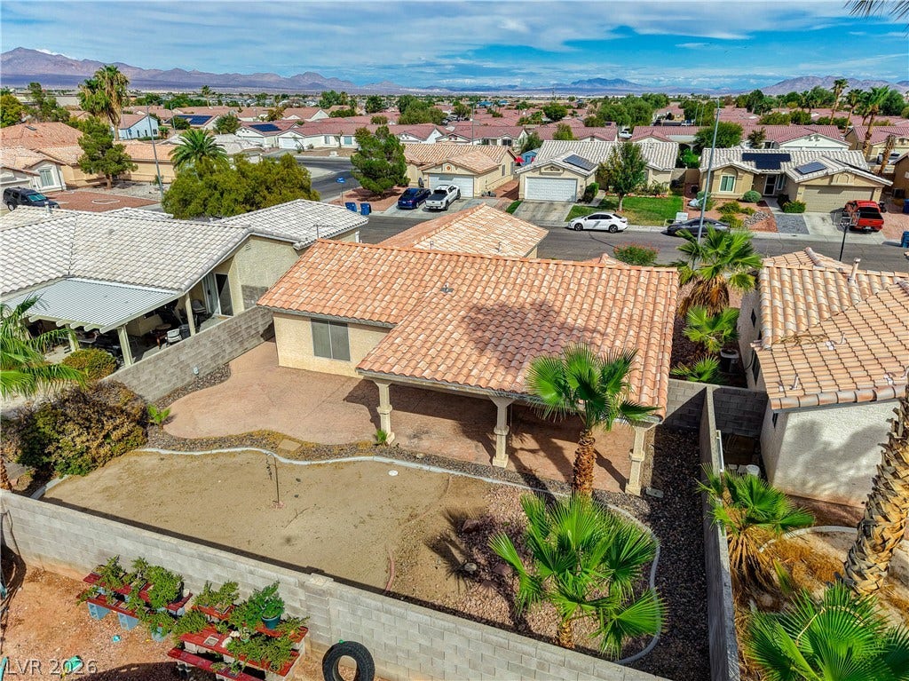 5239 Ferrell Mountain Court, North Las Vegas, NV 89031 Spanish tile roofs and a covered patio highlight this home nestled near distant mountains.
