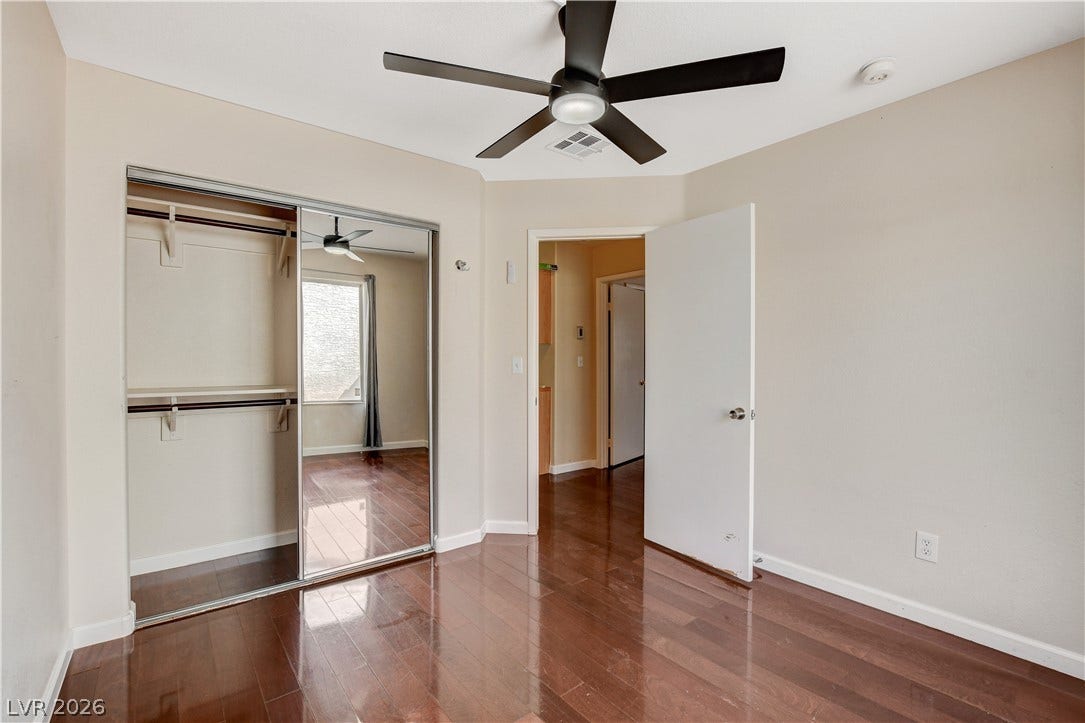 5239 Ferrell Mountain Court, North Las Vegas, NV 89031 Polished wood floors and a mirrored closet maximize natural light in this bedroom.