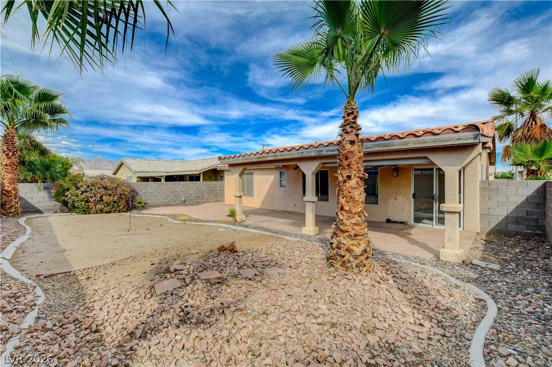 5239 Ferrell Mountain Court, North Las Vegas, NV 89031 Mature palms accent the low-maintenance desert landscaping surrounding the covered rear patio.