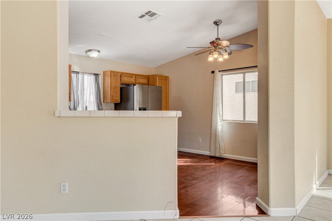 5239 Ferrell Mountain Court, North Las Vegas, NV 89031 Rich wood flooring connects the dining area to a breakfast bar overlooking the kitchen.