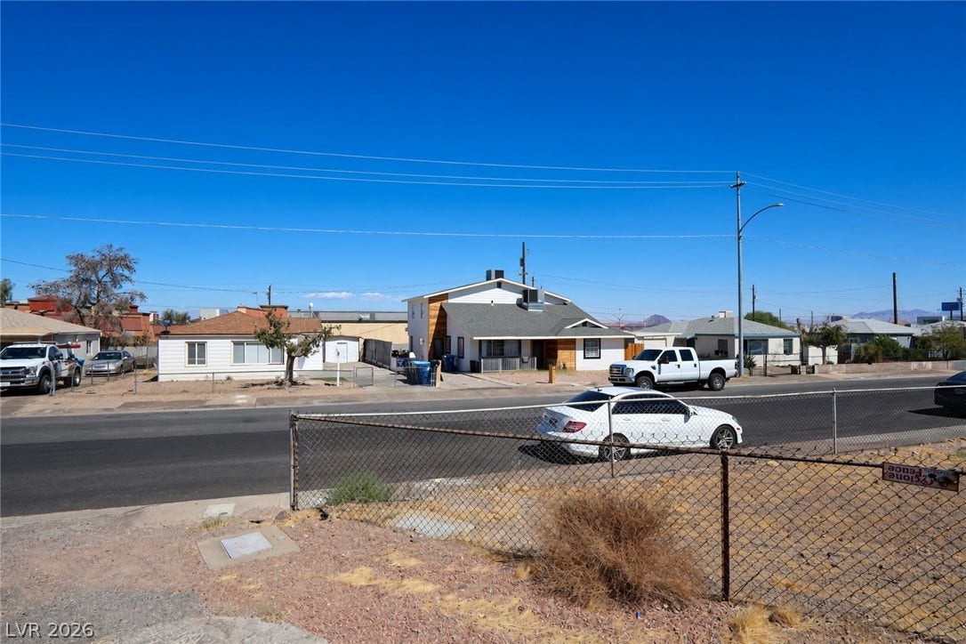 123 W Victory Road, Henderson, NV 89015 A sunny streetscape with neighborhood homes sets the scene for this property.