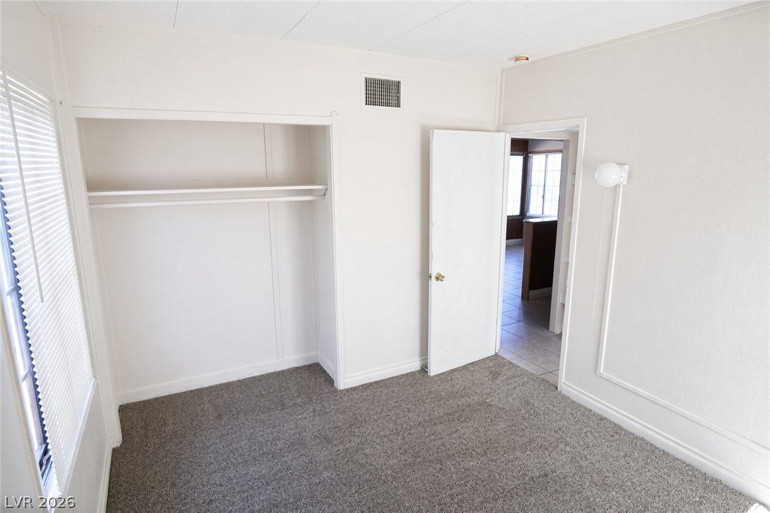 123 W Victory Road, Henderson, NV 89015 Soft carpeting underfoot defines this cozy bedroom complete with built-in closet shelving.