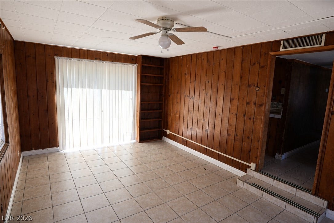 123 W Victory Road, Henderson, NV 89015 Rich wood paneling and durable tile flooring define this classic living space.