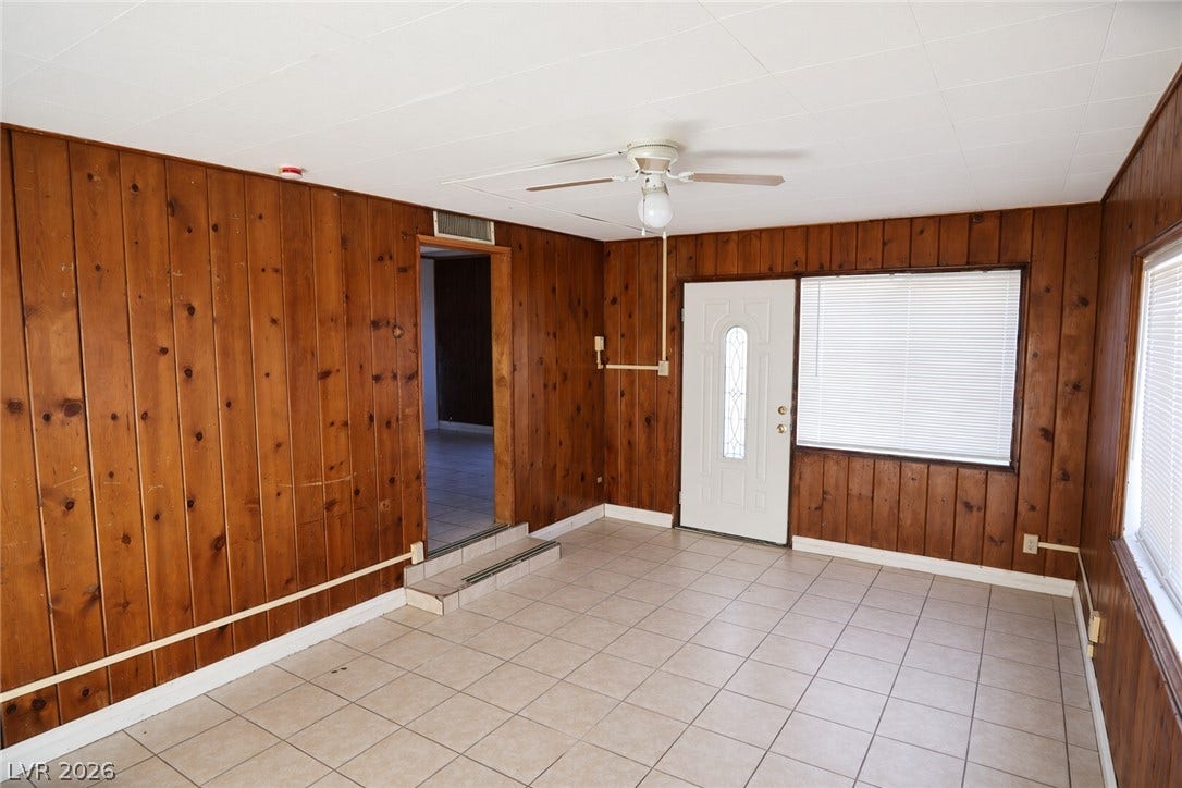 123 W Victory Road, Henderson, NV 89015 Rich wood paneling lines the walls of this tiled living area with private outdoor entry.