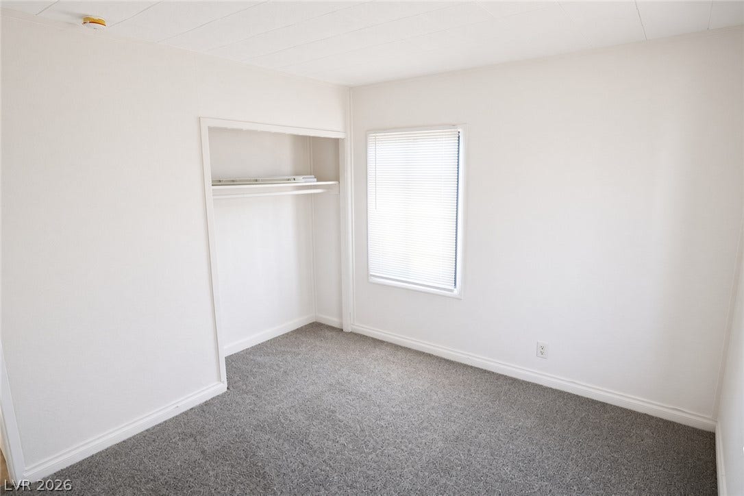 123 W Victory Road, Henderson, NV 89015 Soft carpeting pairs with neutral walls in this versatile bedroom complete with an open closet.