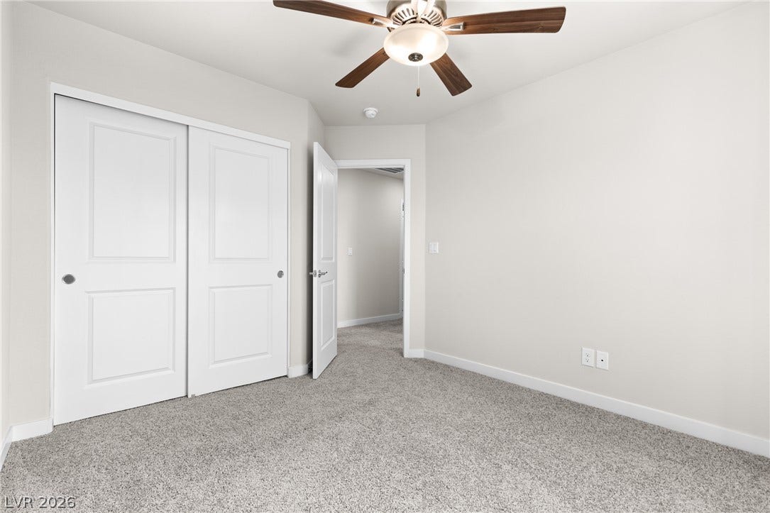 Plush carpeting and neutrally toned walls define this versatile secondary bedroom space.