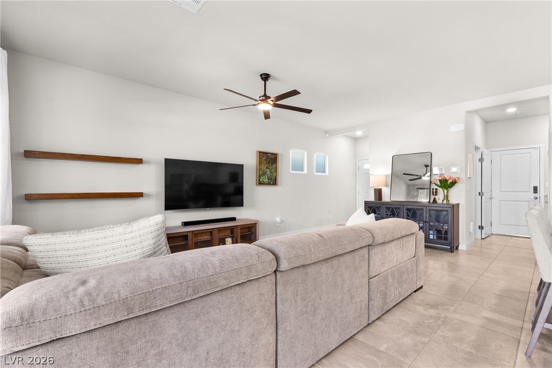 Clean lines and stone tile flooring define this airy, open-concept living space.
