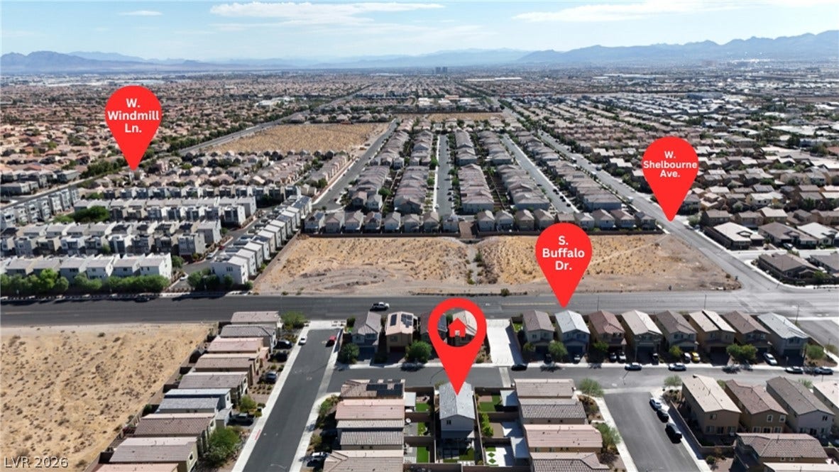 An aerial perspective showcases the surrounding neighborhood context and nearby mountain ridges.
