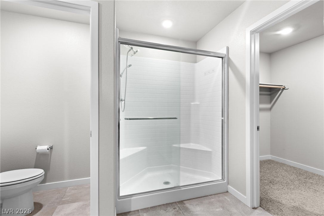 Clean lines and a spacious walk-in shower define this modern bathroom layout.