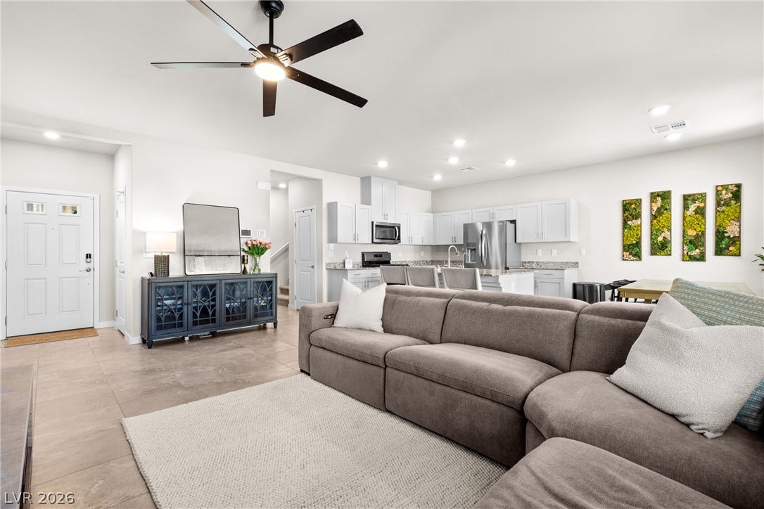 An open floorplan seamlessly connects the central living area to the kitchen.