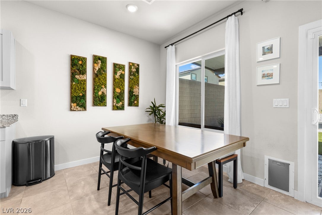 Sliding glass doors open from the dining space directly to the backyard.