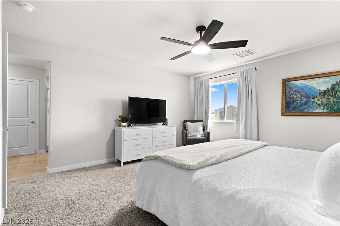Plush carpeting anchors this inviting retreat illuminated by abundant natural light.