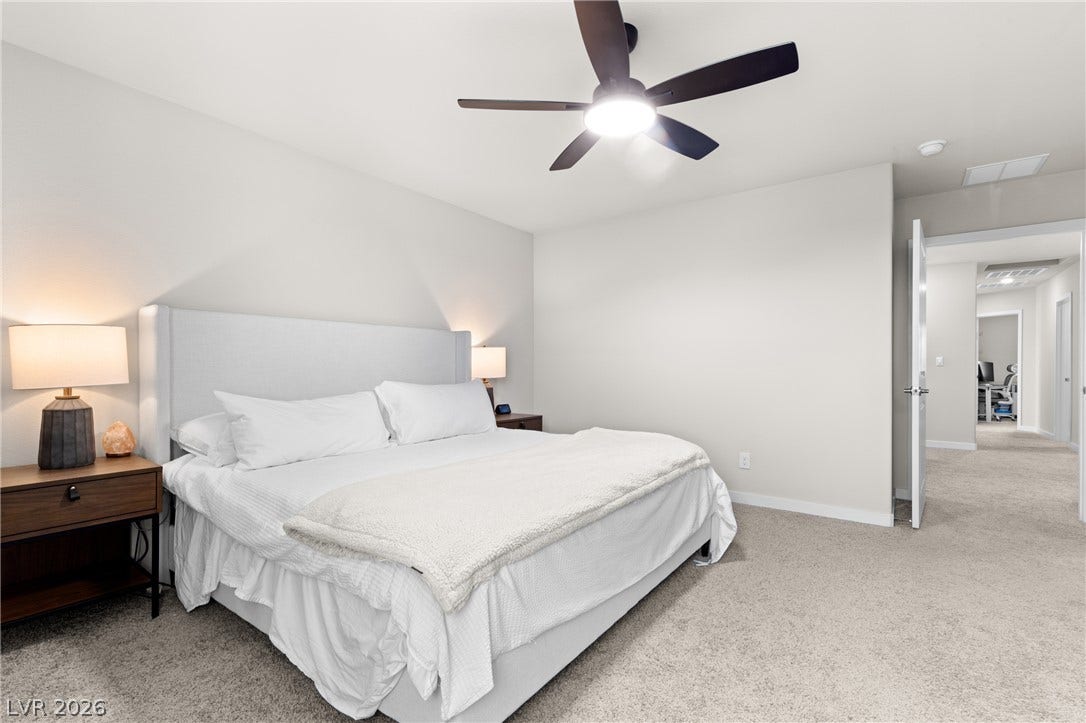 Plush carpeted flooring runs through this comfortable sleeping space offering an open doorway to the hall.