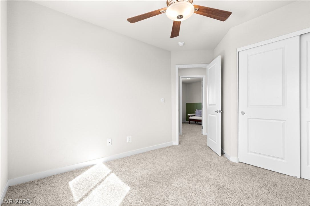 Plush carpeting and clean architectural lines define this versatile bedroom space.