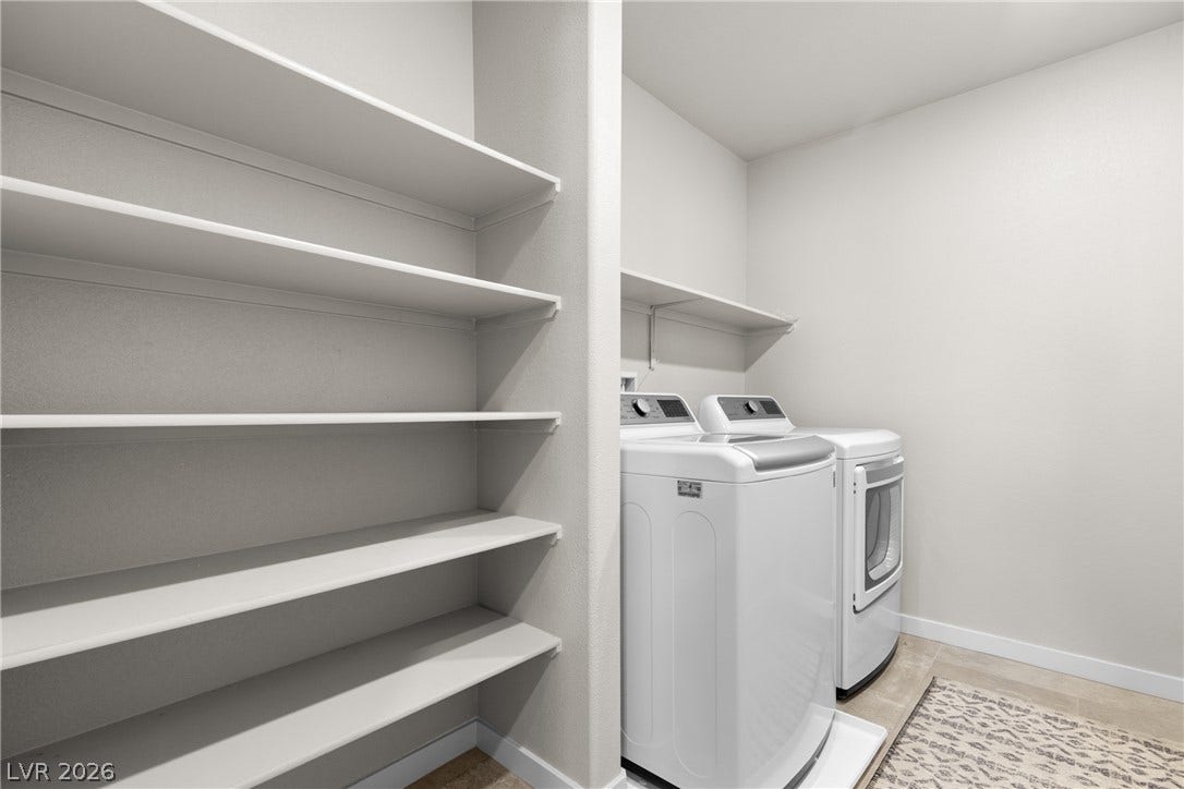 Ample built-in shelving and tile flooring maximize utility in this dedicated utility space.