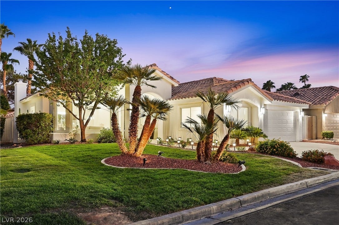 1612 Hidden Spring Drive, Las Vegas, NV 89117 Manicured desert landscaping and a clay tile roof define this elegant single-story facade.