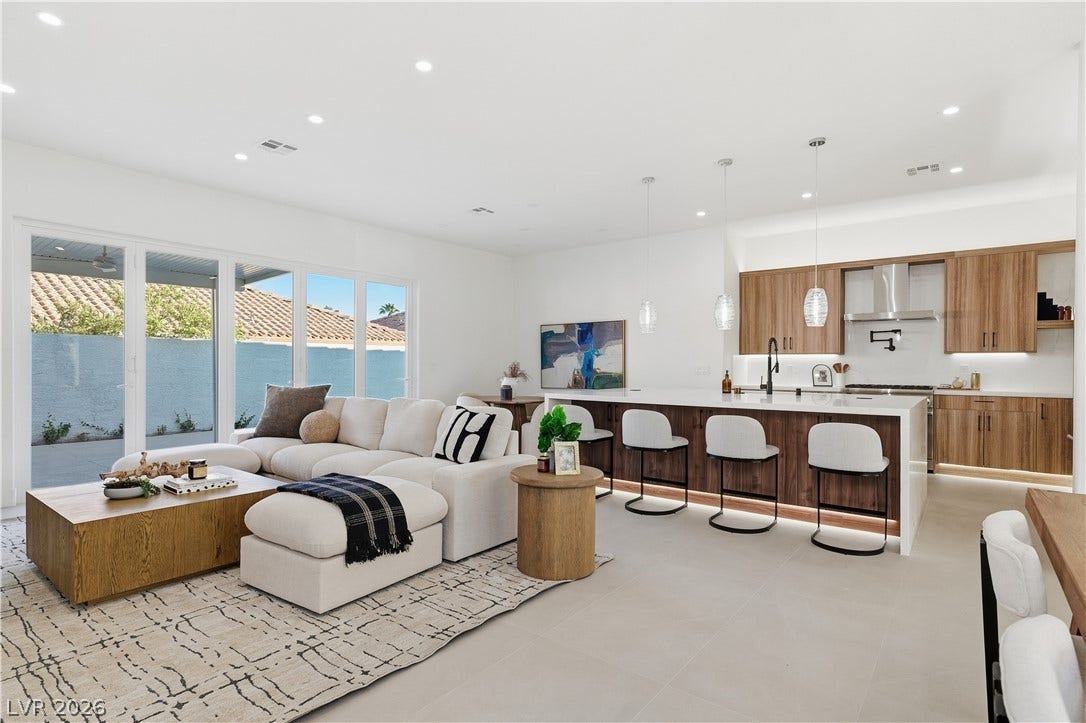1612 Hidden Spring Drive, Las Vegas, NV 89117 An open-concept living area and kitchen display clean lines and large sliding glass doors.