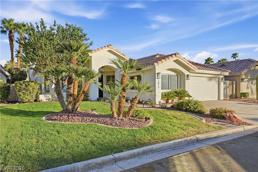 1612 Hidden Spring Drive, Las Vegas, NV 89117 Manicured desert landscaping frames the classic stucco exterior of this single-story residence.
