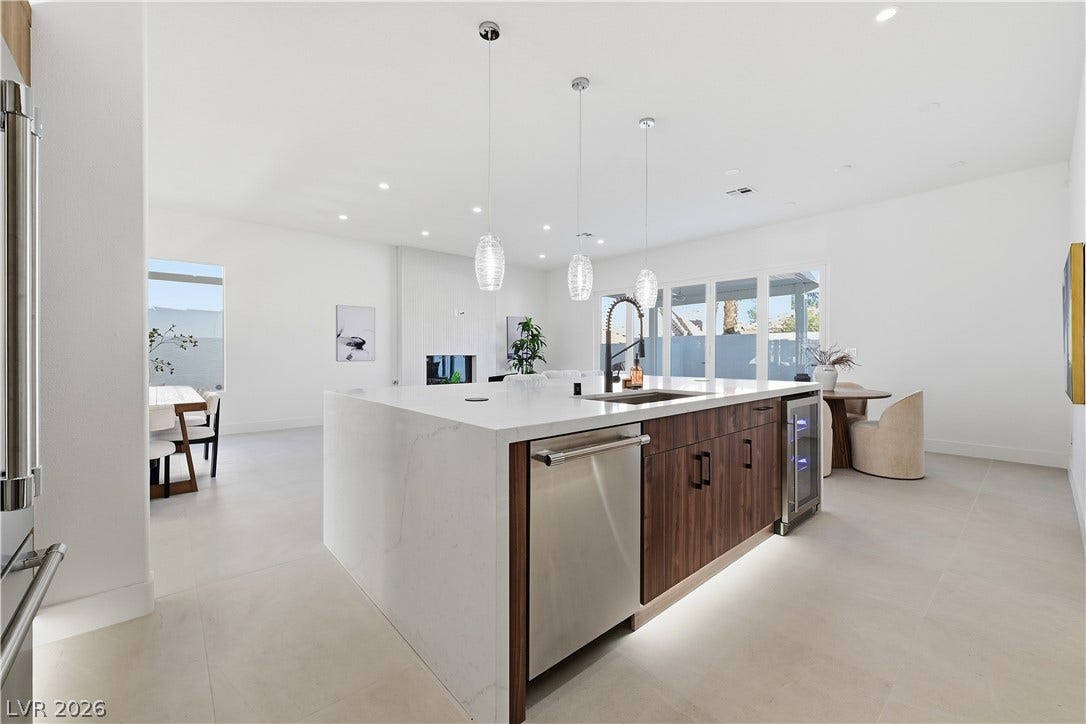 1612 Hidden Spring Drive, Las Vegas, NV 89117 Clean lines and a spacious waterfall island define this modern, open-concept kitchen.