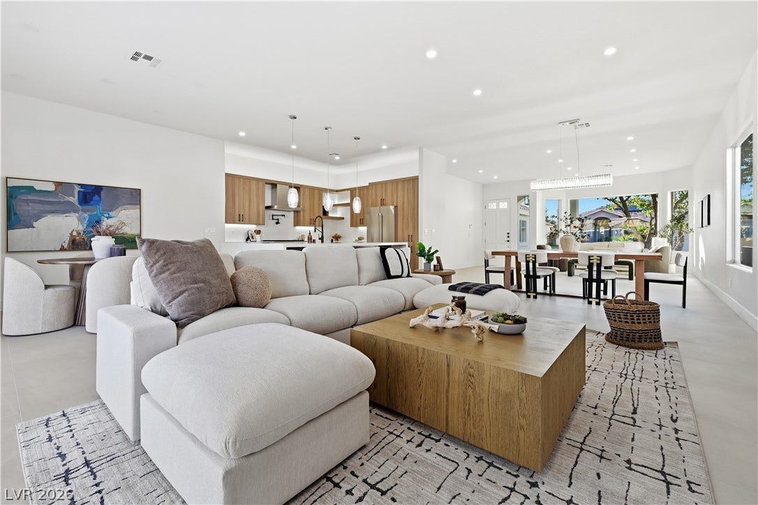 1612 Hidden Spring Drive, Las Vegas, NV 89117 A spacious open-concept interior seamlessly connects the living area, kitchen, and dining space.