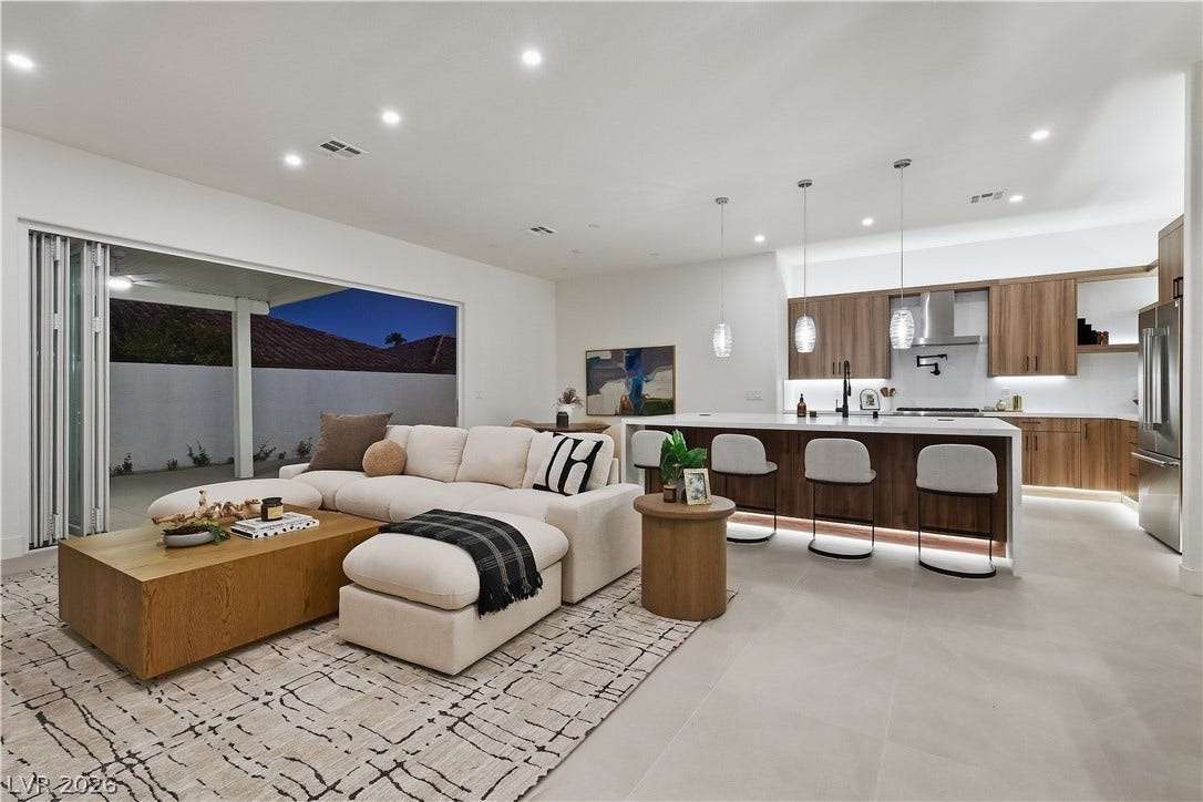 1612 Hidden Spring Drive, Las Vegas, NV 89117 Retractable glass doors seamlessly connect this modern open living space to the outdoors.